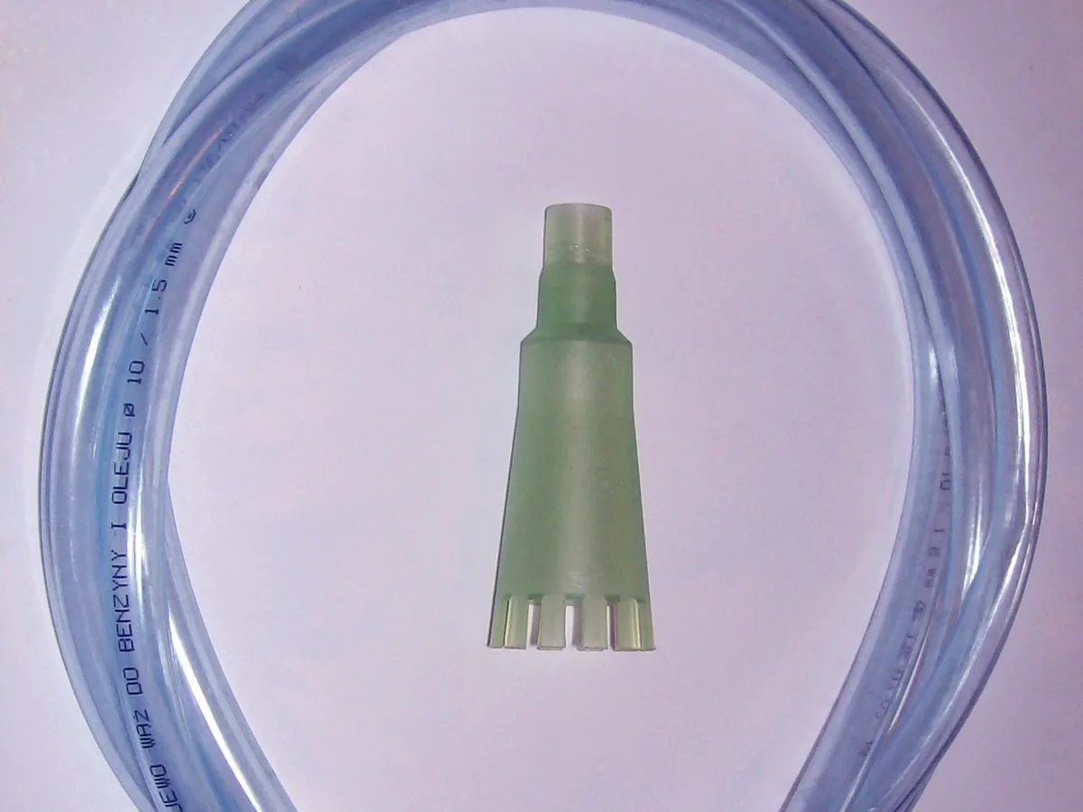 Aquarium gravel cleaner: a ribbed plastic siphon bell beside a coil of clear tubing